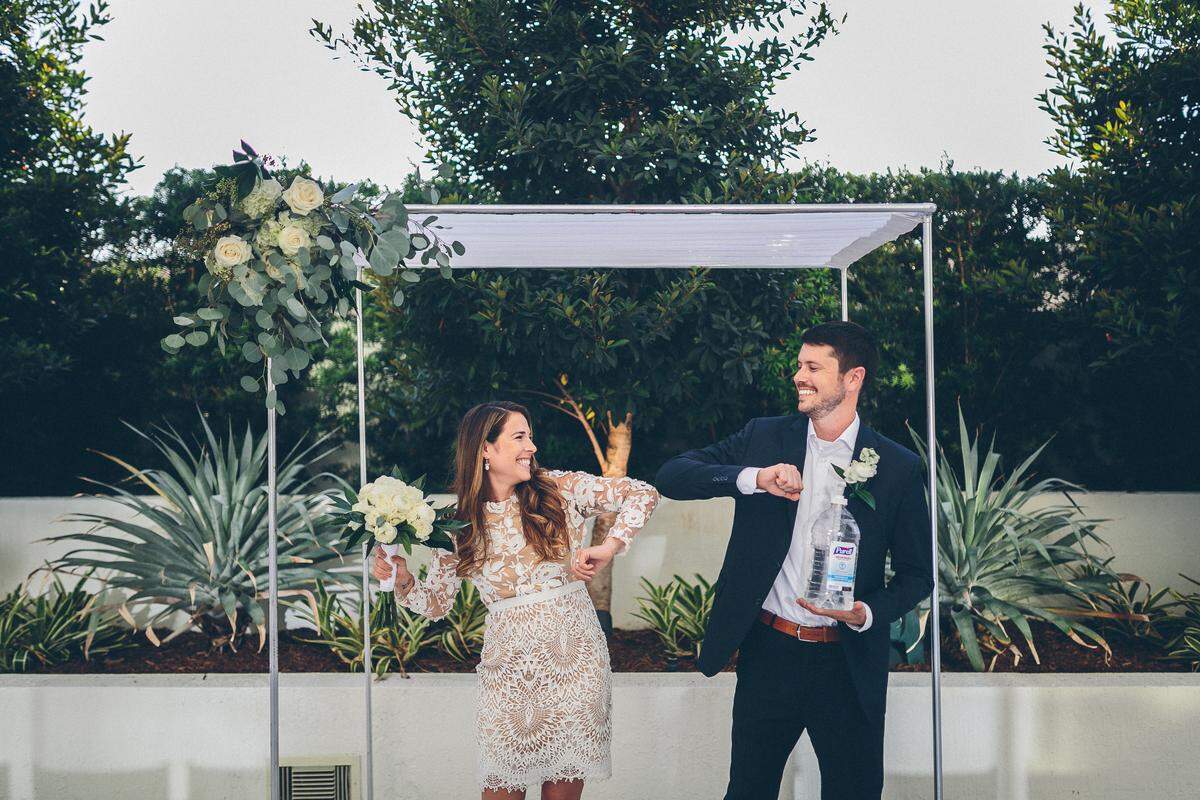 Newlyweds Charlotte Jay and Blake Parker exchange an elbow bump at their hastily rescheduled, live-streamed wedding on Tuesday where 12 guests were treated to dollops of Purell. The Hollywood couple postponed their big wedding for one year because of the coronavirus pandemic.