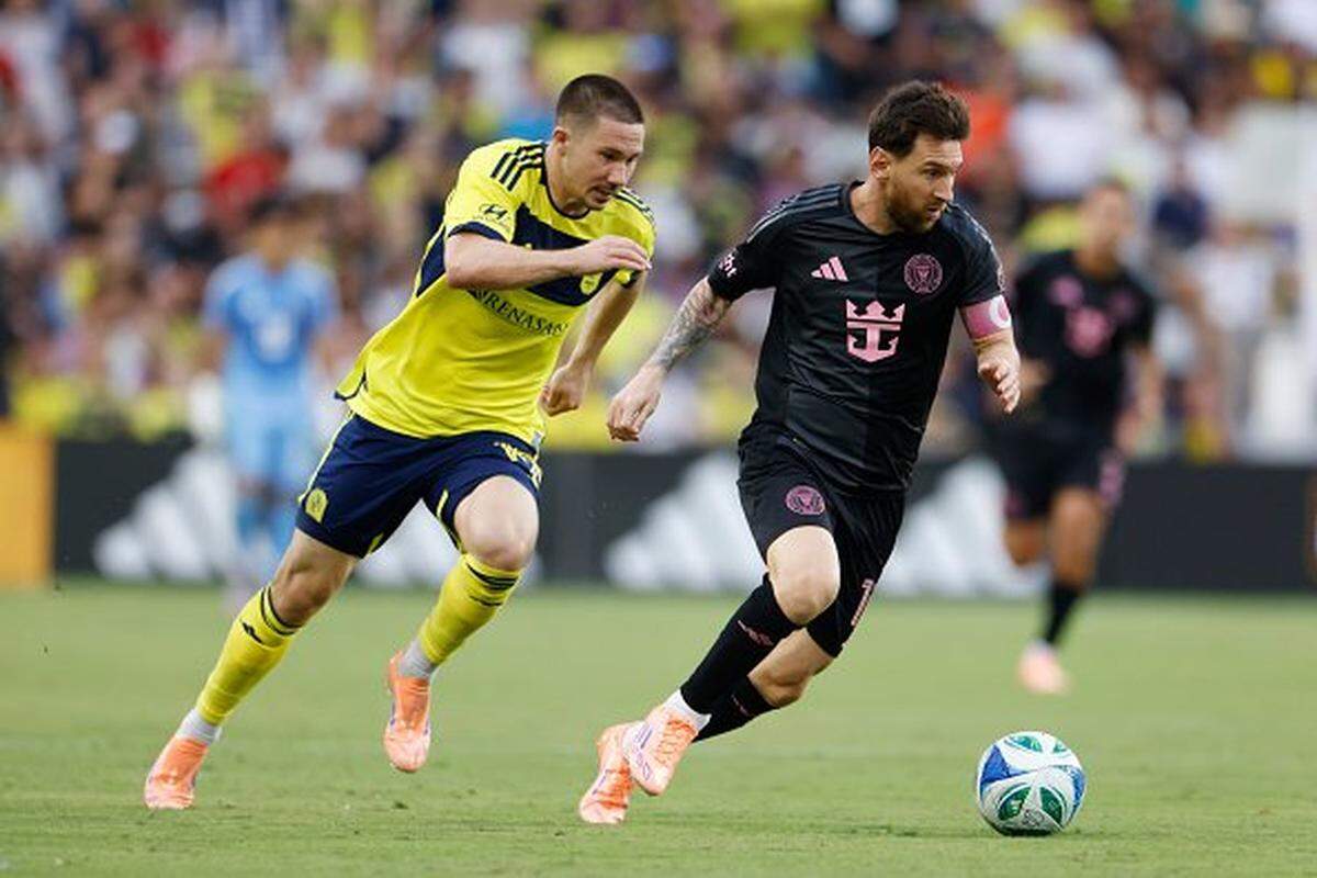NASHVILLE, TENNESSEE - OCTOBER 18: Lionel Messi #10 of Inter Miami CF is challenged Alex Muyl #19 of Nashville SC during the MLS match between Nashville SC and Inter Miami CF at GEODIS Park on October 18, 2025 in Nashville, Tennessee. 