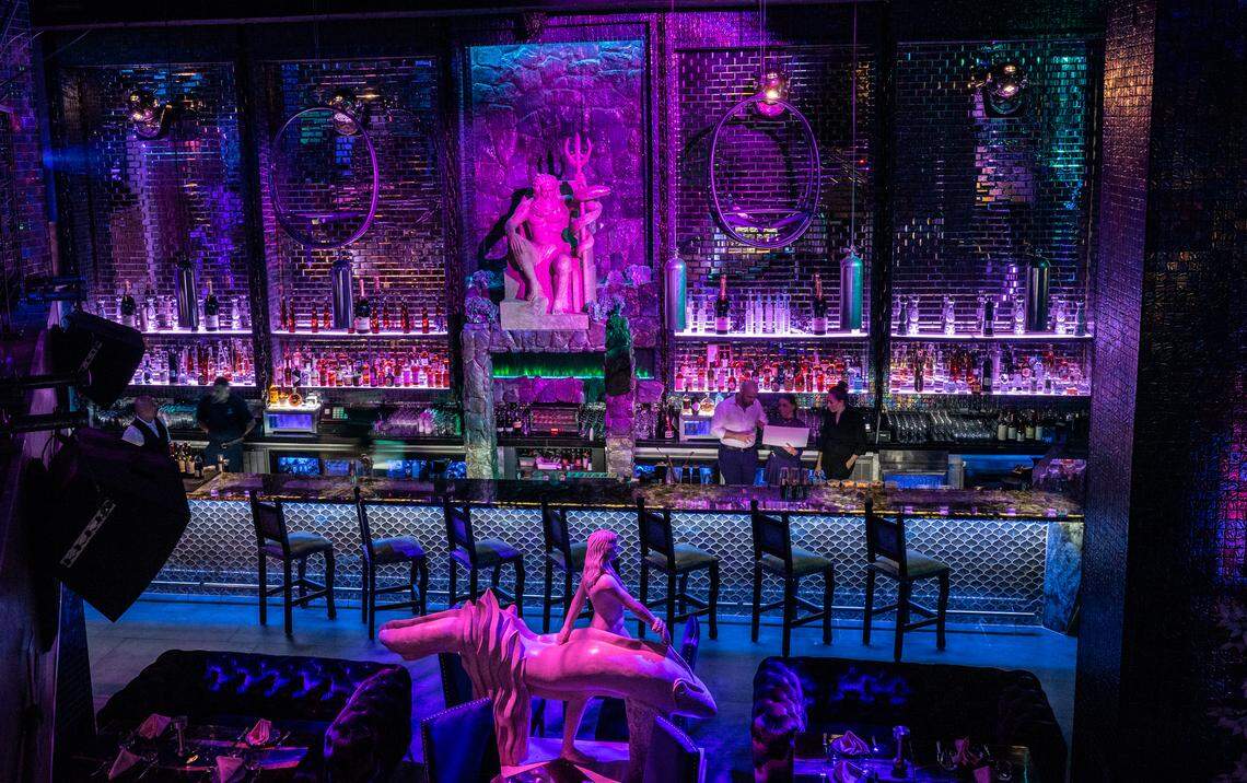 A sculpture of Poseidon reigns over the bar at Wet in Brickell.