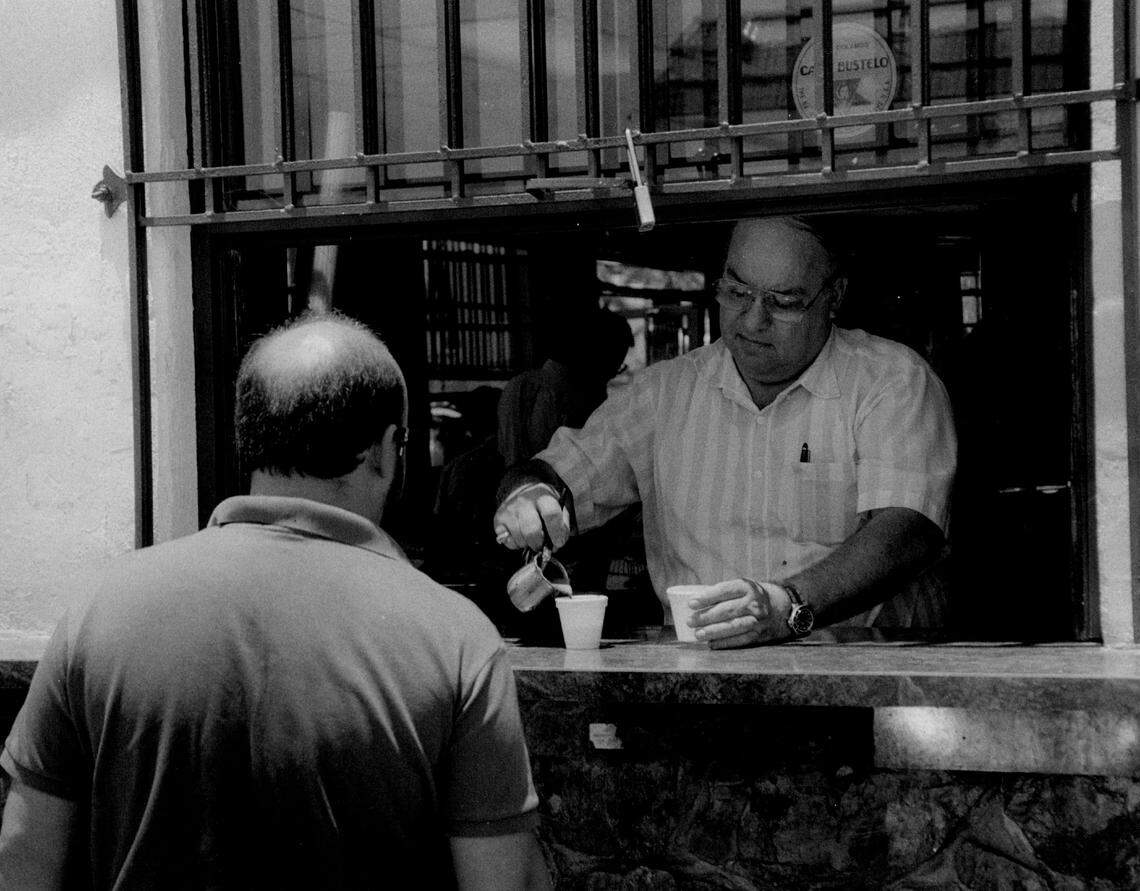 Pedro Orta serves Cuban coffee at the Oasis Sandwich Shop in Key Biscayne.