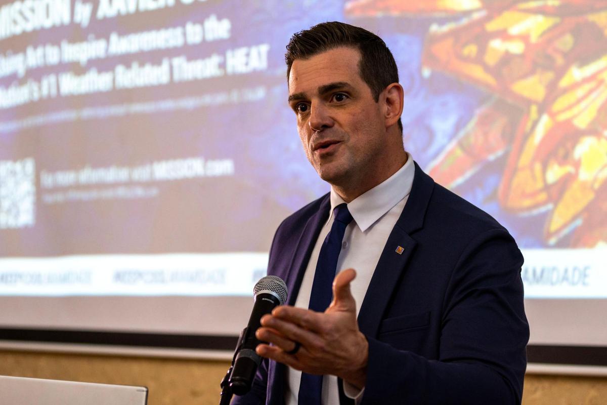 Chris Valletta, founder of Mission, a maker of apparel to help people stay cool on hot days, talks to guests during an event in Coral Gables where artist Xavier Cortada unveiled decorative cooling towels he created in partnership with Mission.