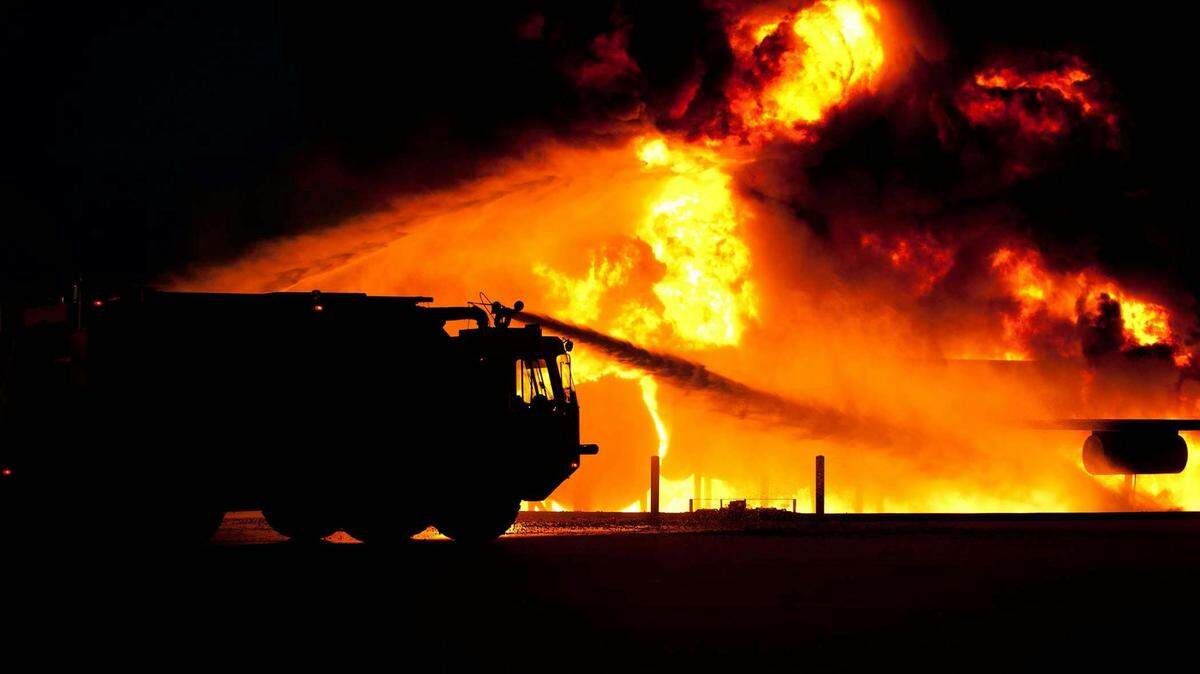 firetruck spraying water house fire