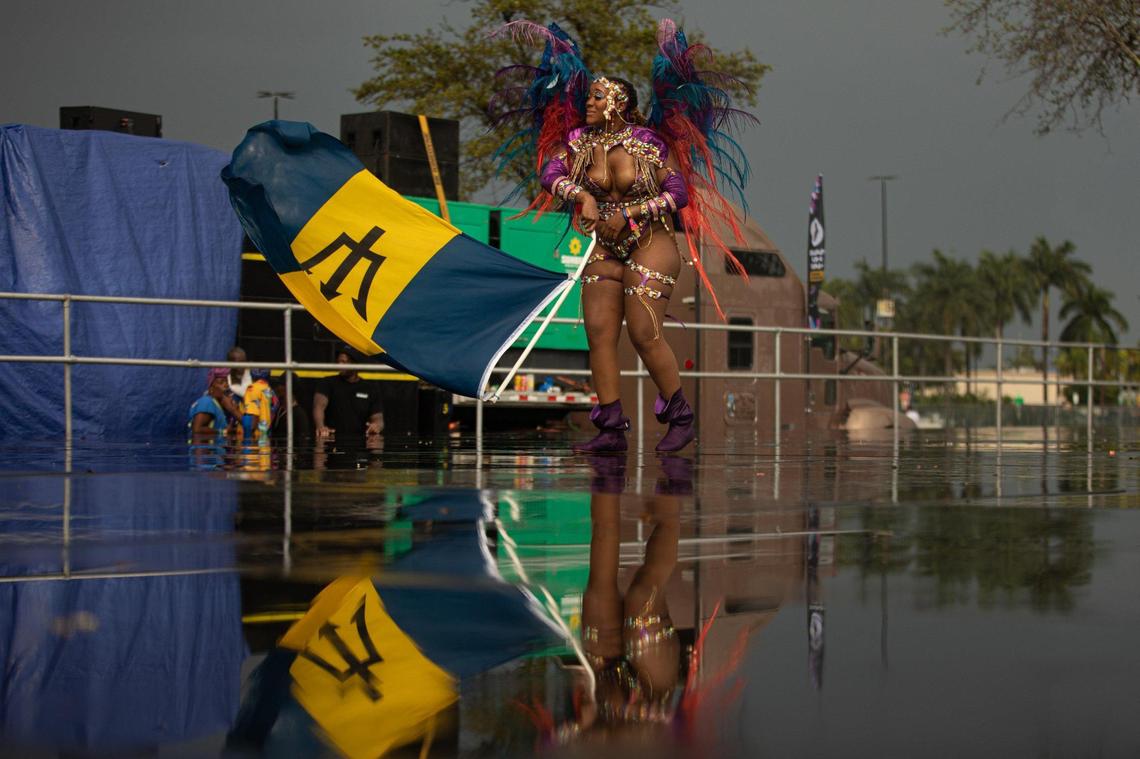 A performer dances with a flag on stage during Miami Carnival at the Miami-Dade County Fair Expo in Miami, Florida on Sunday, October 9, 2022.