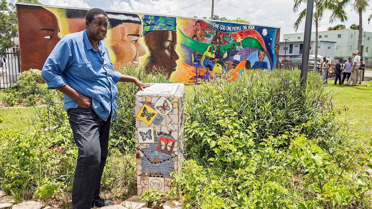 Sunday, July 1, 2018- David Jenkins, father of Sherdavia Jenkins stands next to the monument and time capsule in honor of his daughter who was killed by a stray bullet in 2006 as an annual remembrance is held in her honor. The park is called Sherdavia Jenkins Peace Park which is located on the corner of Dr. Martin Luther King Boulevard on NW 62nd street and 12th avenue in Miami and the gathering is to pay tribute  to Sherdavia and more than 300 other kids killed in Miami-Dade over the past decade.