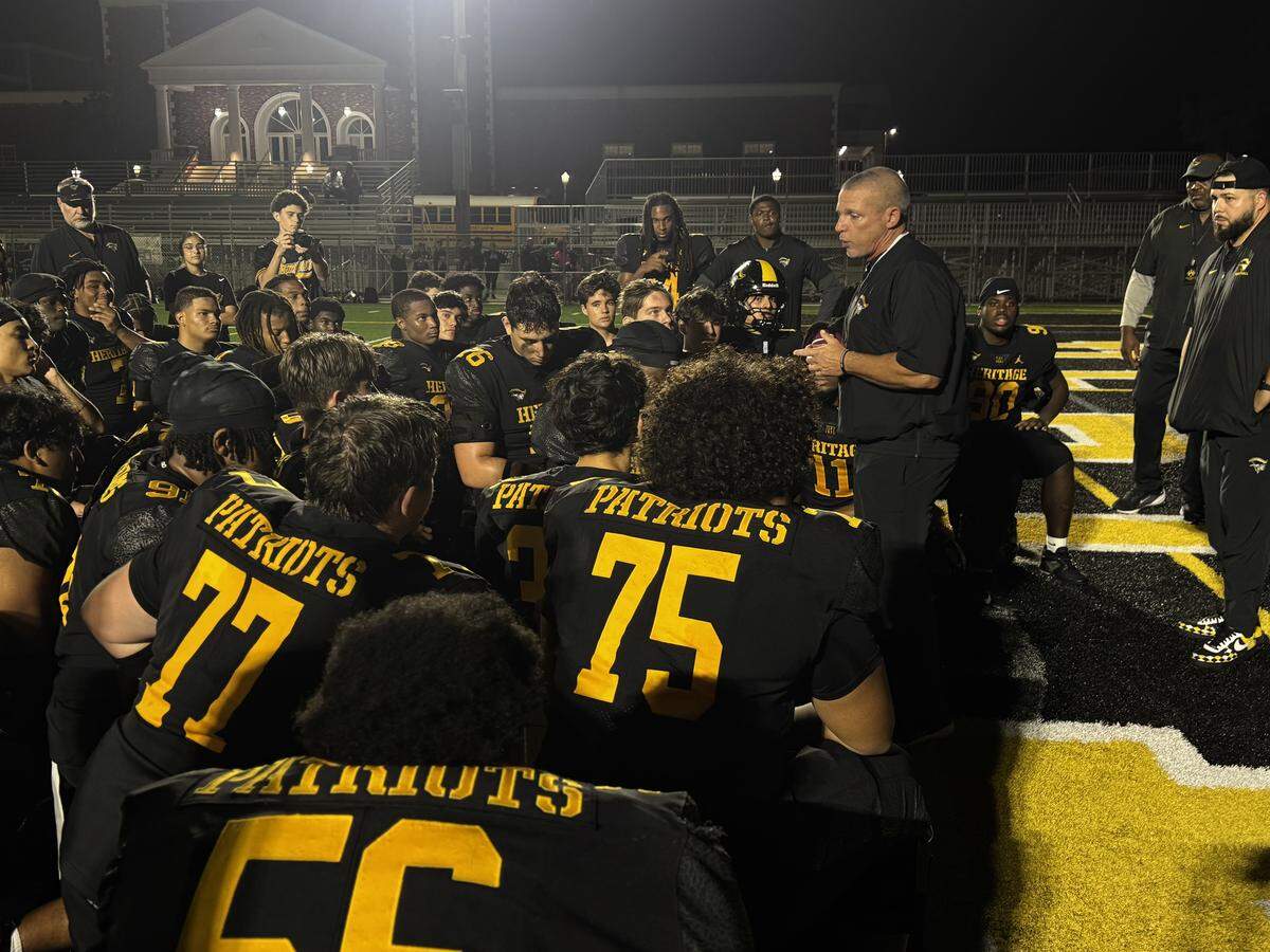 American Heritage football coach Mike Smith speaks to the Patriots after Friday’s 48-7 win over Plantation in a Region 4-4A semifinal at Heritage.