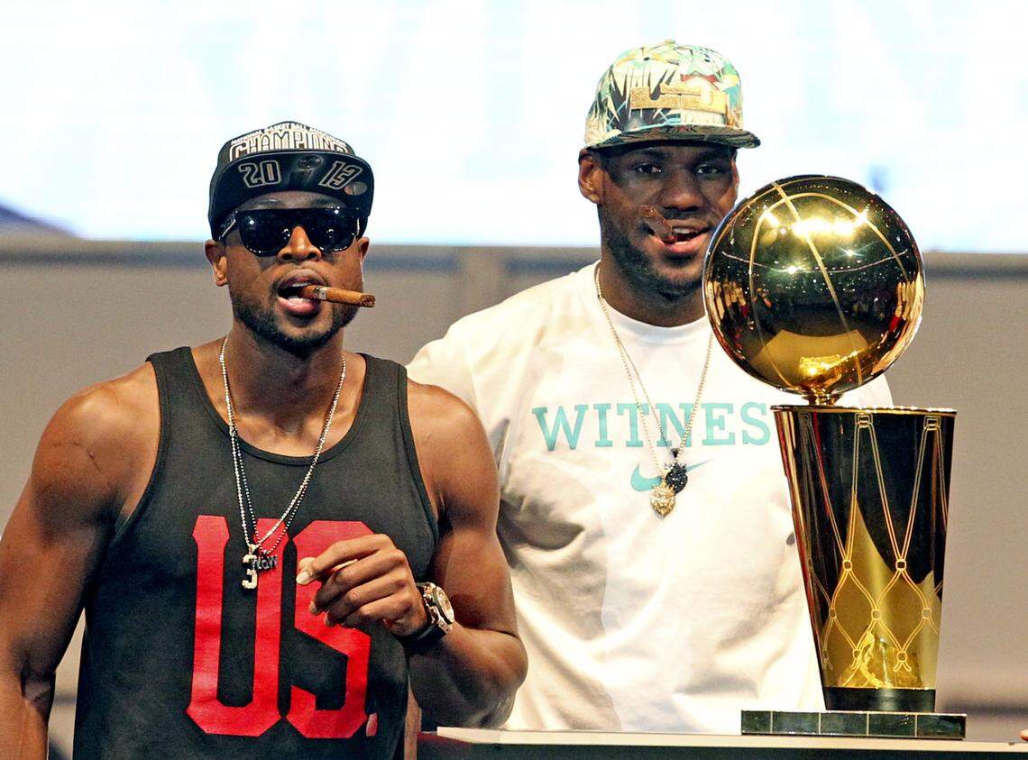 Miami Heat’s Dwyane Wade and LeBron James are introduced as they walk toward the Larry O’Brien trophy at their celebration of their 2013 NBA Championship at AmericanAirlines Arena in Miami, Florida, June 24, 2013.