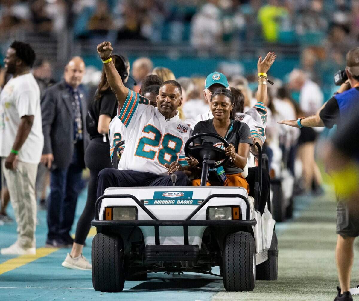Former Miami Dolphins Ed Jenkins (28) reacts to the crowd during a ceremony celebrating the Miami Dolphins’ 1972 perfect season during the half time of an NFL football game between the Dolphins and the Pittsburgh Steelers at Hard Rock Stadium on Sunday, Oct. 23, 2022, in Miami Gardens, Fla.