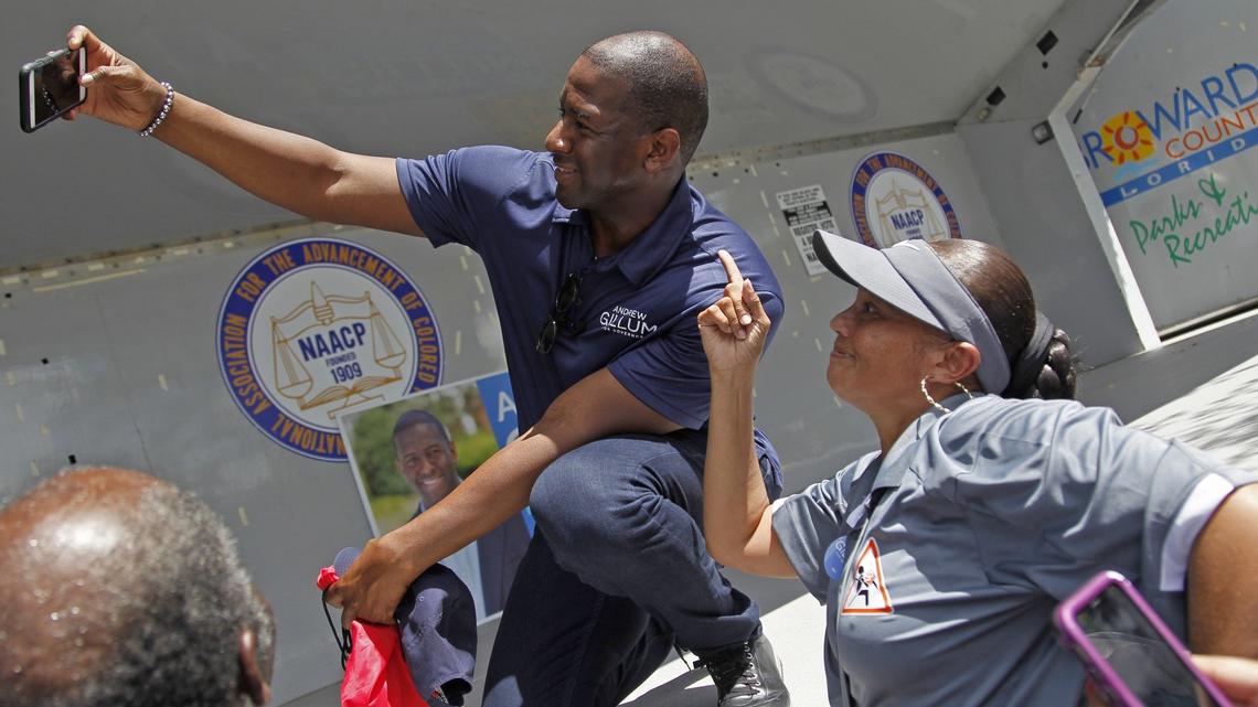 Gubernatorial candidate Andrew Gillum, left, takes a quick selfie with a supporter as Democratic candidates for governor, judgeships, local offices, and Congress marched over one mile towards Reverend Samuel Delevoe Memorial Park during the “Souls to the Polls” event to encourage voter participation and early voting on Sunday, August 26, 2018, in Fort Lauderdale.