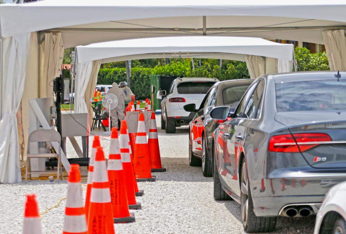 Vehicles line up at the coronavirus antibody test drive through site in Bal Harbour Shops as the Novel coronavirus pandemic continues on Wednesday, May 13, 2020 in Bal Harbour.