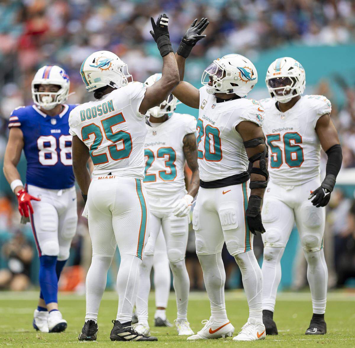 Miami Dolphins linebackers Jordyn Brooks (20) and Tyrel Dodson (25) react after a play against the Buffalo Bills in the first half of their NFL game at Hard Rock Stadium on Sunday, Nov. 9, 2025, in Miami Gardens, Fla.