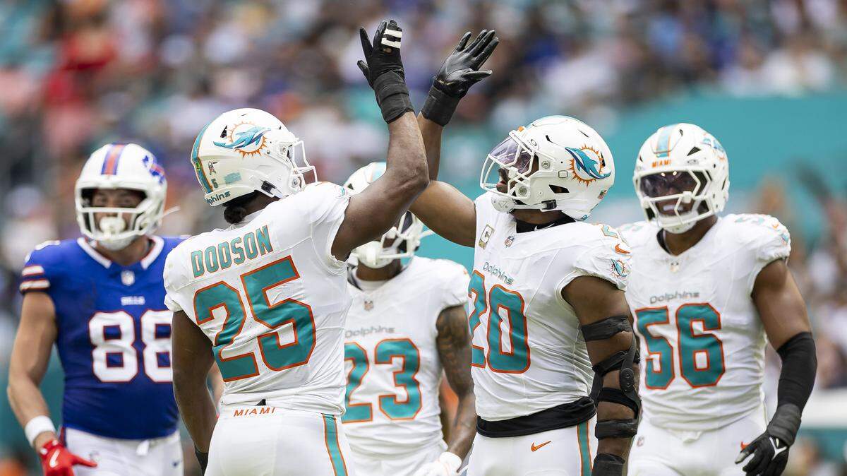 Miami Dolphins linebackers Jordyn Brooks (20) and Tyrel Dodson (25) react after a play against the Buffalo Bills in the first half of their NFL game at Hard Rock Stadium on Sunday, Nov. 9, 2025, in Miami Gardens, Fla.