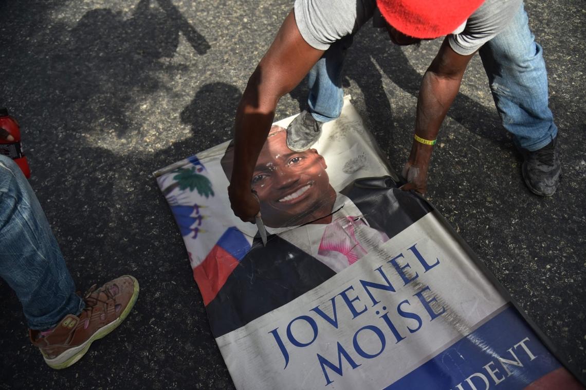 Protesters destroy a poster of Haitian President Jovenel Moise as they demonstrate in the Port-au-Prince suburb of Petion-Ville on July 7, 2018, against a hike in fuel prices. Haiti's Prime Minister, Jack Guy Lafontant, on Saturday called for patience from residents of the Caribbean nation amid deadly protests over an unpopular fuel price rise. At least one person has died there in the past day. The capital has stood paralyzed since July 6, following the government announcement that gasoline prices would rise by 38 percent, diesel by 47 percent and kerosene by 51 percent starting this weekend.