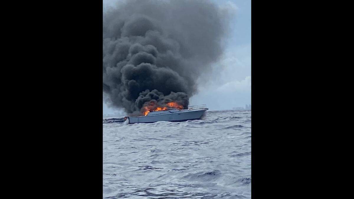 A 30-foot boat burns about five nautical miles off Port Everglades on June 3, 2021. Coast Guard Station Fort Lauderdale crew rescued its two passengers.,