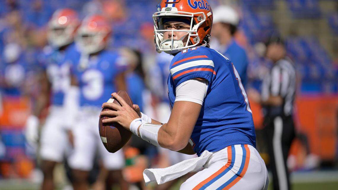 FILE -Florida quarterback Jalen Kitna (11) warms up before an NCAA college football game against Eastern Washington, Sunday, Oct. 2, 2022, in Gainesville, Fla. Florida backup quarterback Jalen Kitna, the son of retired NFL quarterback Jon Kitna, was arrested Wednesday, Nov. 30, 2022 and charged with two counts of distribution of child exploitation material and three counts of possession of child pornography. (AP Photo/Phelan M. Ebenhack, File)