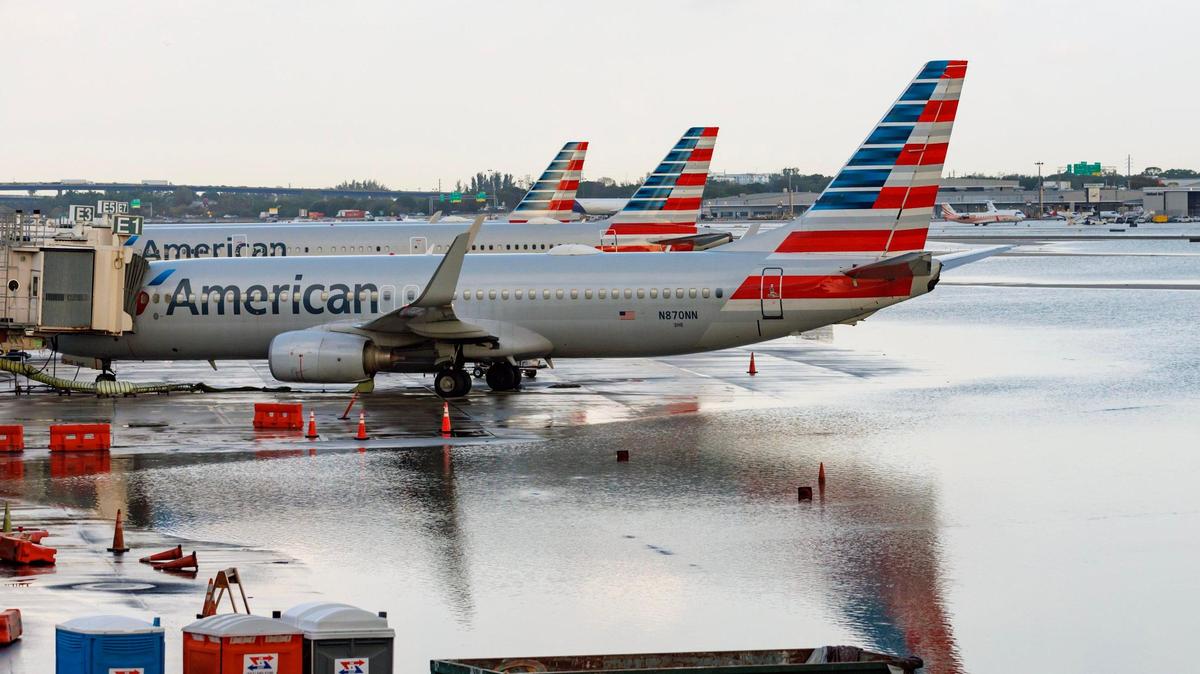 File photo from April 13, 2023, shows American Airlines airplanes at their terminal on flooded runway from heavy rain at Fort Lauderdale-Hollywood International Airport.