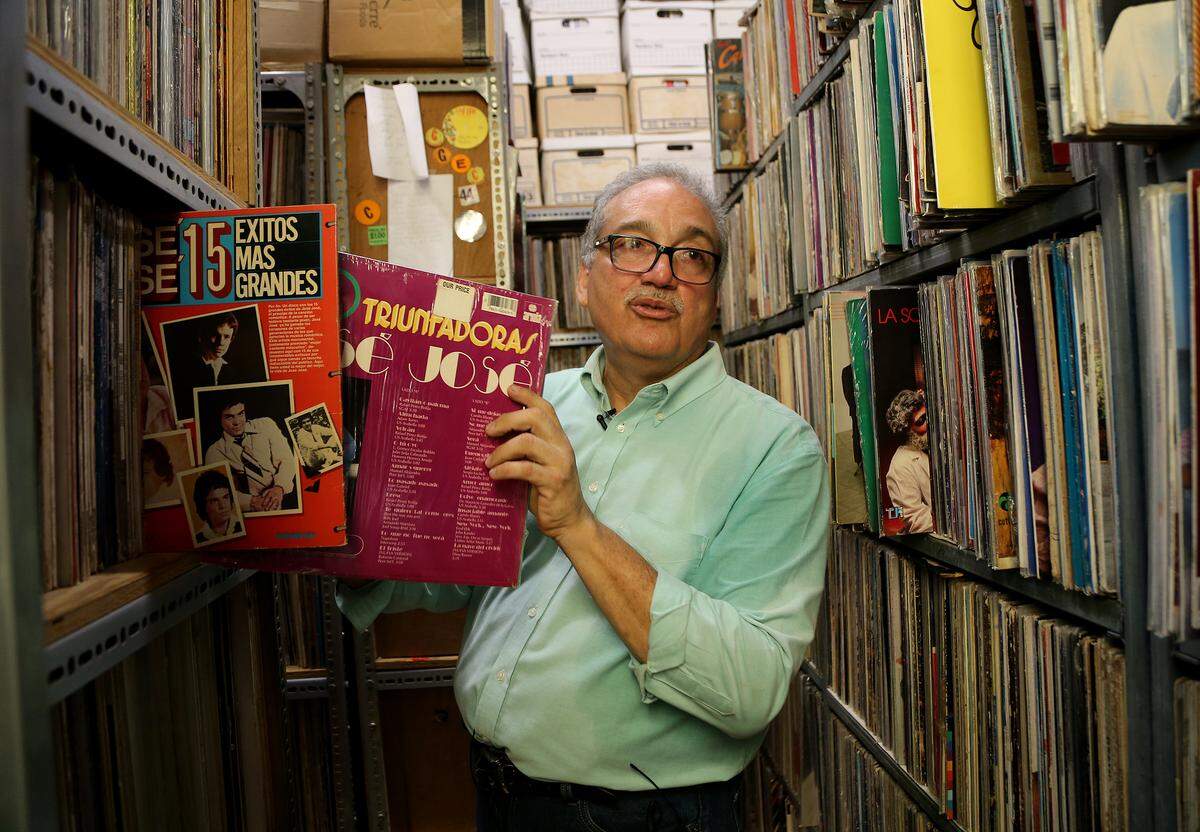 Javier Santiago, director of the National Foundation for Popular Culture, displays some of Puerto Rican artist Jose Feliciano’s vinyl albums, part of a music collection kept in the foundation’s building on corner of La Fortaleza street leading to the governor’s mansion.