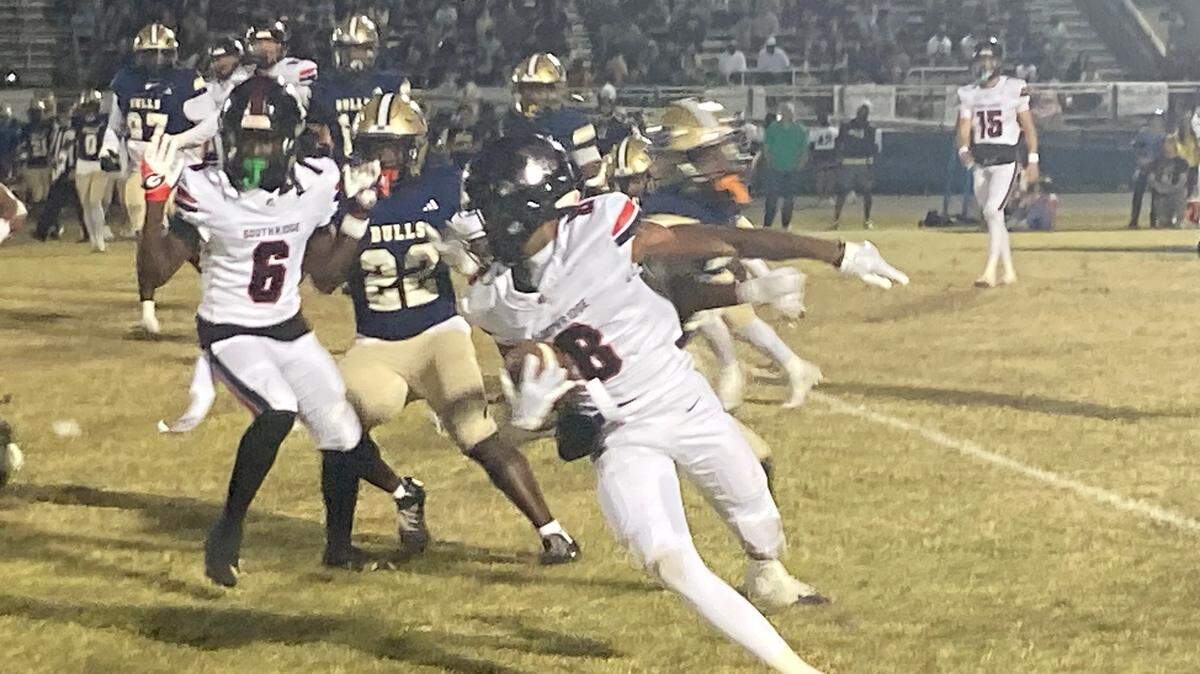 Miami Southridge wide receiver Darius Clements tries to skirt around West Boca Raton defenders during Friday’s Class 6A state semifinal at West Boca Raton High School.