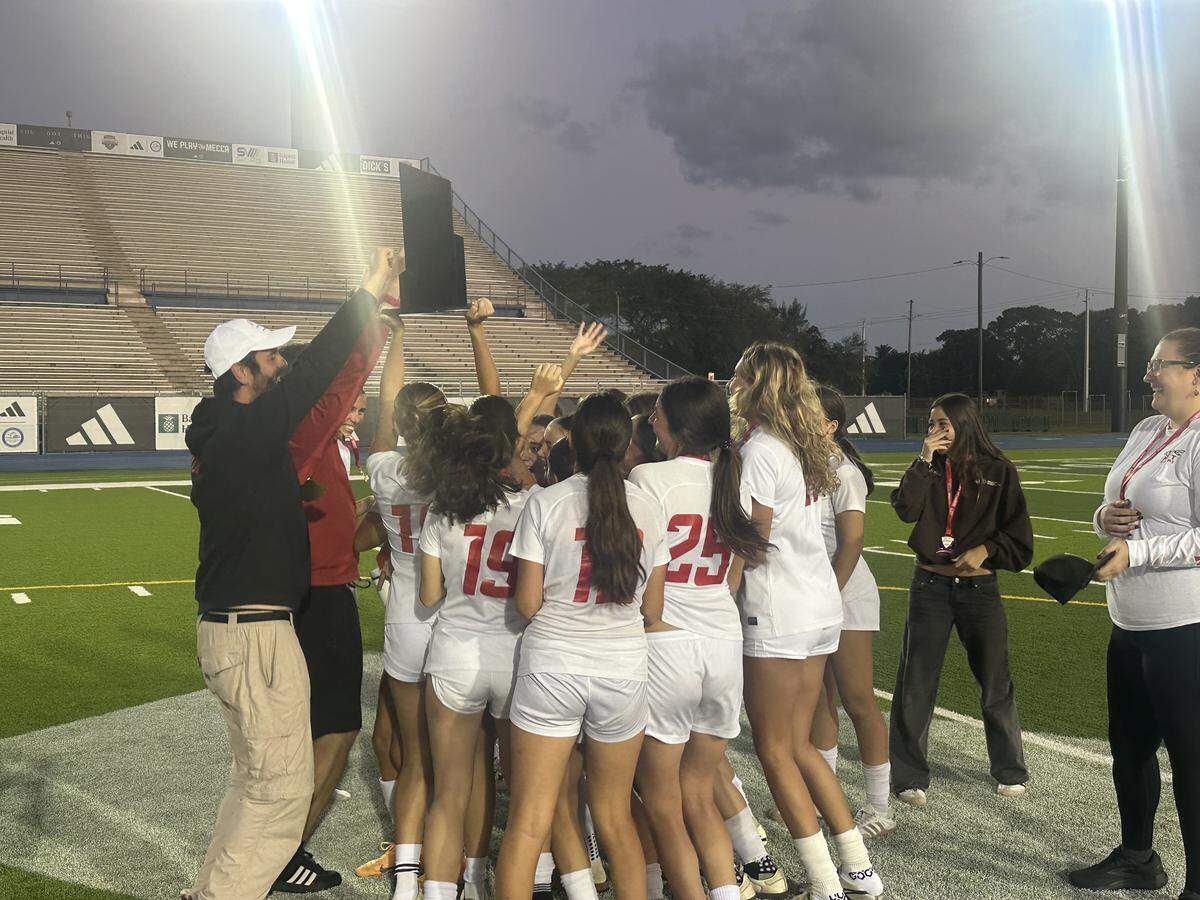 MAST Academy’s girls’ soccer team celebrates with the GMAC championship trophy on Friday at Traz Powell Stadium after beating Palmetto in the final.