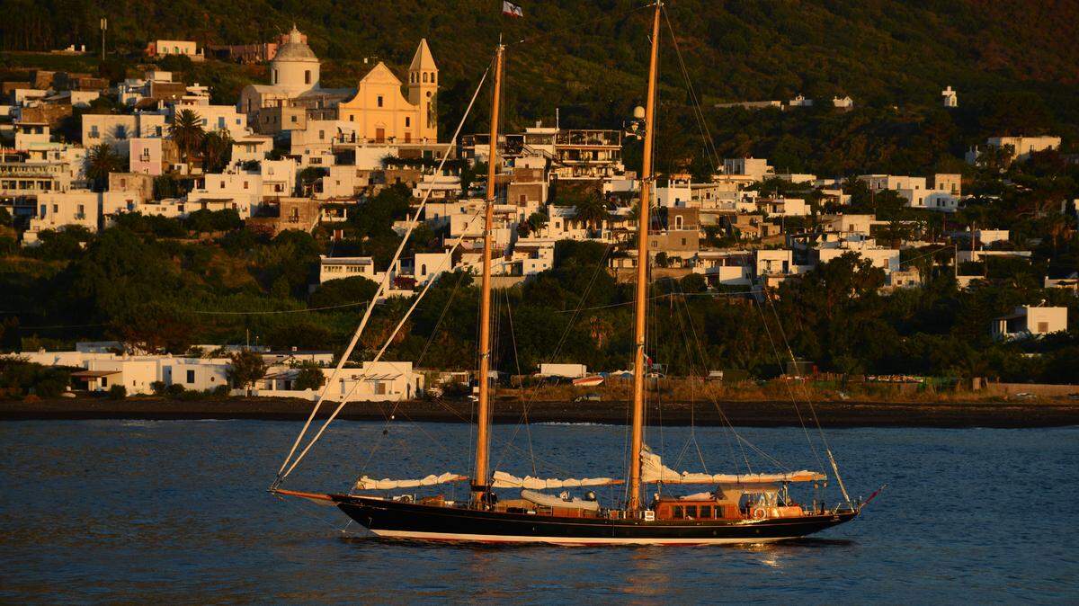 A sailboat is anchored in front of the small village of Stromboli, on June 15, 2016. Stromboli is part of the Aeolian Islands a volcanic archipelago in the Tyrrhenian Sea, north of Sicily.