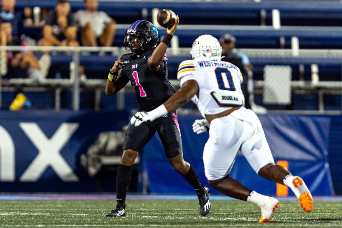 Florida International University quarterback Keyone Jenkins (1) throws the ball as University of Texas at El Paso defensive end Maurice Westmoreland (0) rushes during the first half of a college football game at Riccardo Silva Stadium in Miami, Florida, on Wednesday October 11, 2023.