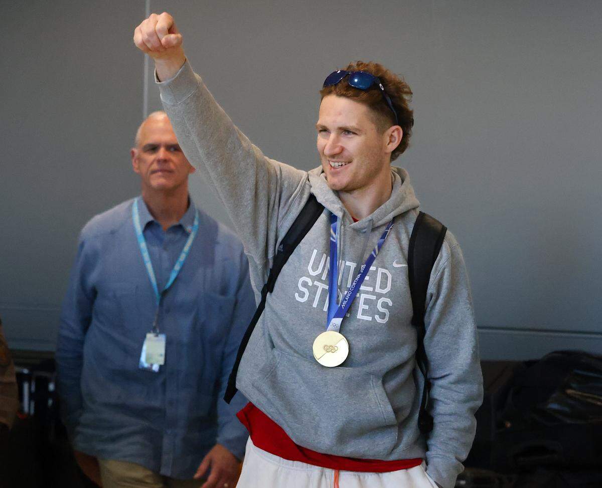 Matthew Tkachuk of the United States, wearing his gold medal, greets fans upon arrival at Miami International Airport on Monday, Feb. 23, 2026, in Miami, after returning from Milan following the Americans' gold-medal victory over Canada at the 2026 Winter Olympics in Milano Cortina, Italy.