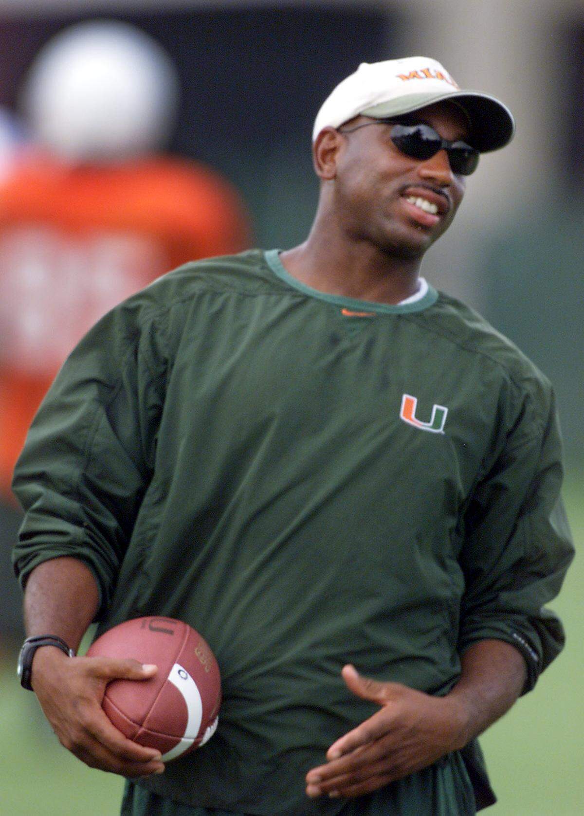 UM wide receivers coach Curtis Johnson watches his player on the first day of freshman practice on Aug. 8, 2002.