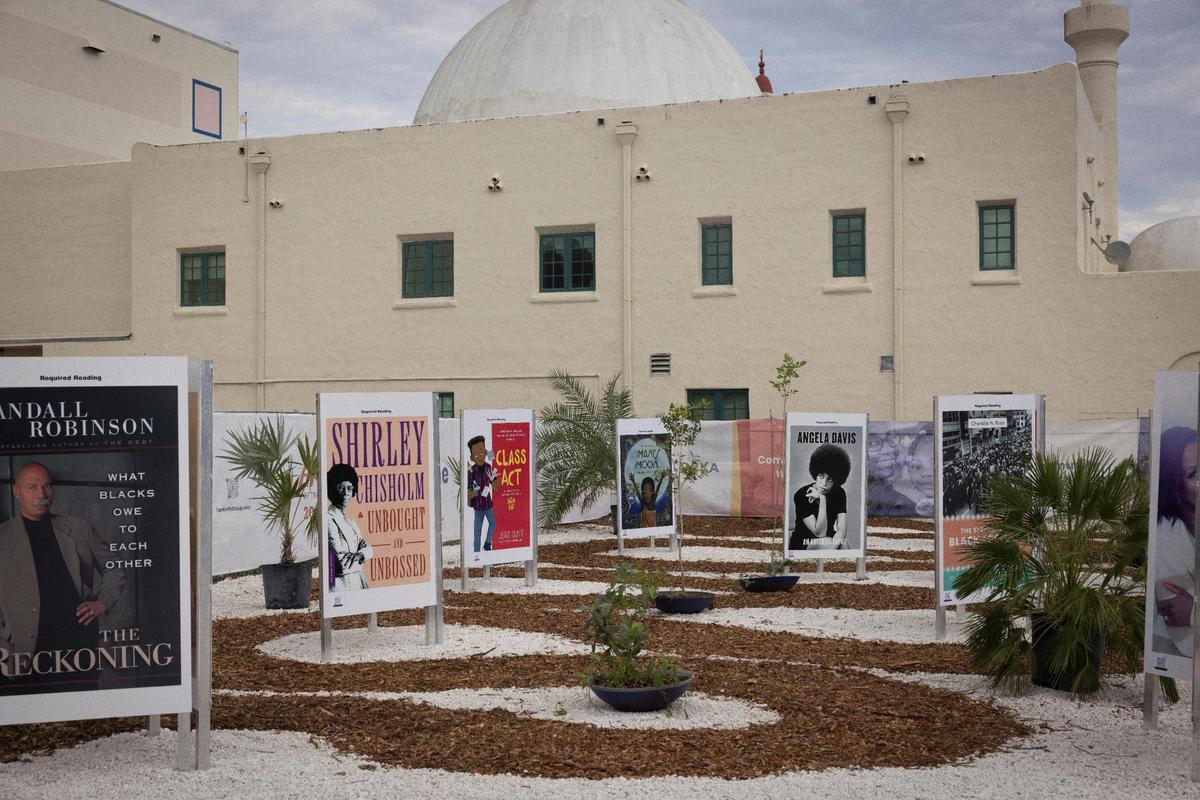 Required Reading, a walk through exhibit that displays the banned books in Florida, sits in the landscape garden during the “Art of Transformation” exhibit preview on Monday, Dec. 4, 2023, outside the ARC in Opa-Locka.