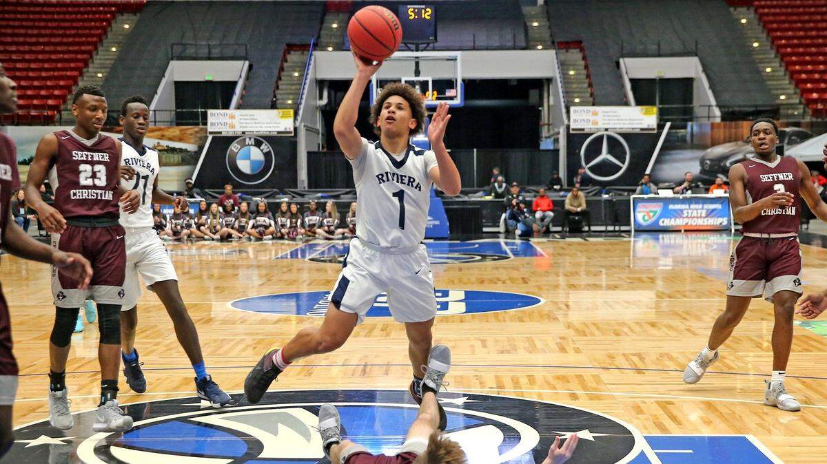 Riviera Prep Esteban Lluberes (1) knocks over Seffner Christian Reagan Flatt (15) as Lluberes shoots in the Class 4A Boy’s Semi-Finals State Basketball Championships at the RP Funding Center in Lakeland, Florida, Wednesday, March, 6, 2019.