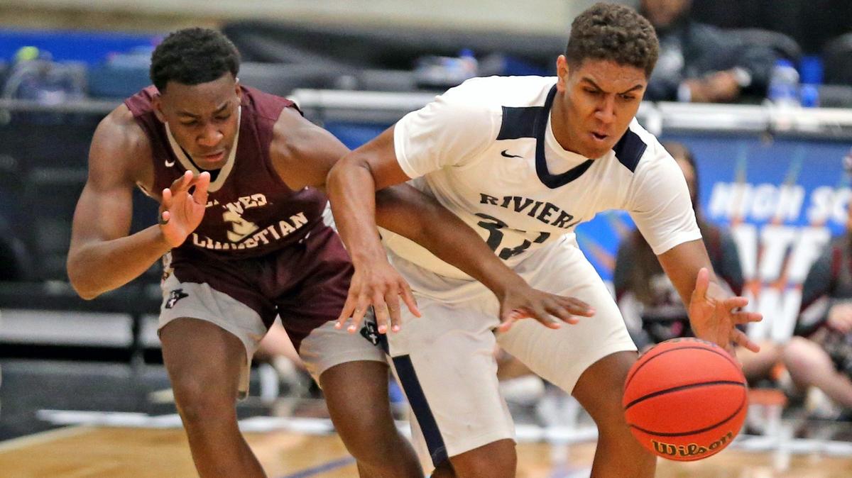 Riviera Prep Osmar Garcia-Araujo (32) protects the ball from Seffner Christian Mike Tiggs (3) in the Class 4A Boy’s Semi-Finals State Basketball Championships at the RP Funding Center in Lakeland, Florida, Wednesday, March, 6, 2019.