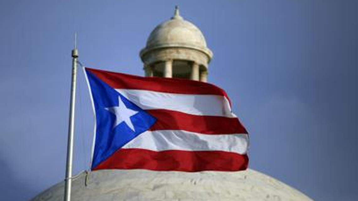 The Puerto Rican flag flies in front of the island’s Capitol in San Juan.