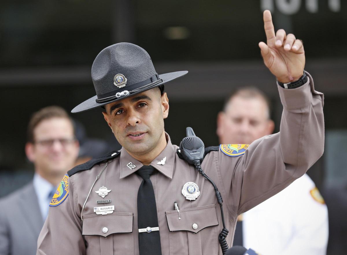 Florida Highway Patrol Trooper Carlos Rosario points to the heavens and thanks God for his recovery during ceremony celebrating his return to work on Wednesday, January 9, 2019, nearly two years after being critically injured in a crash.
