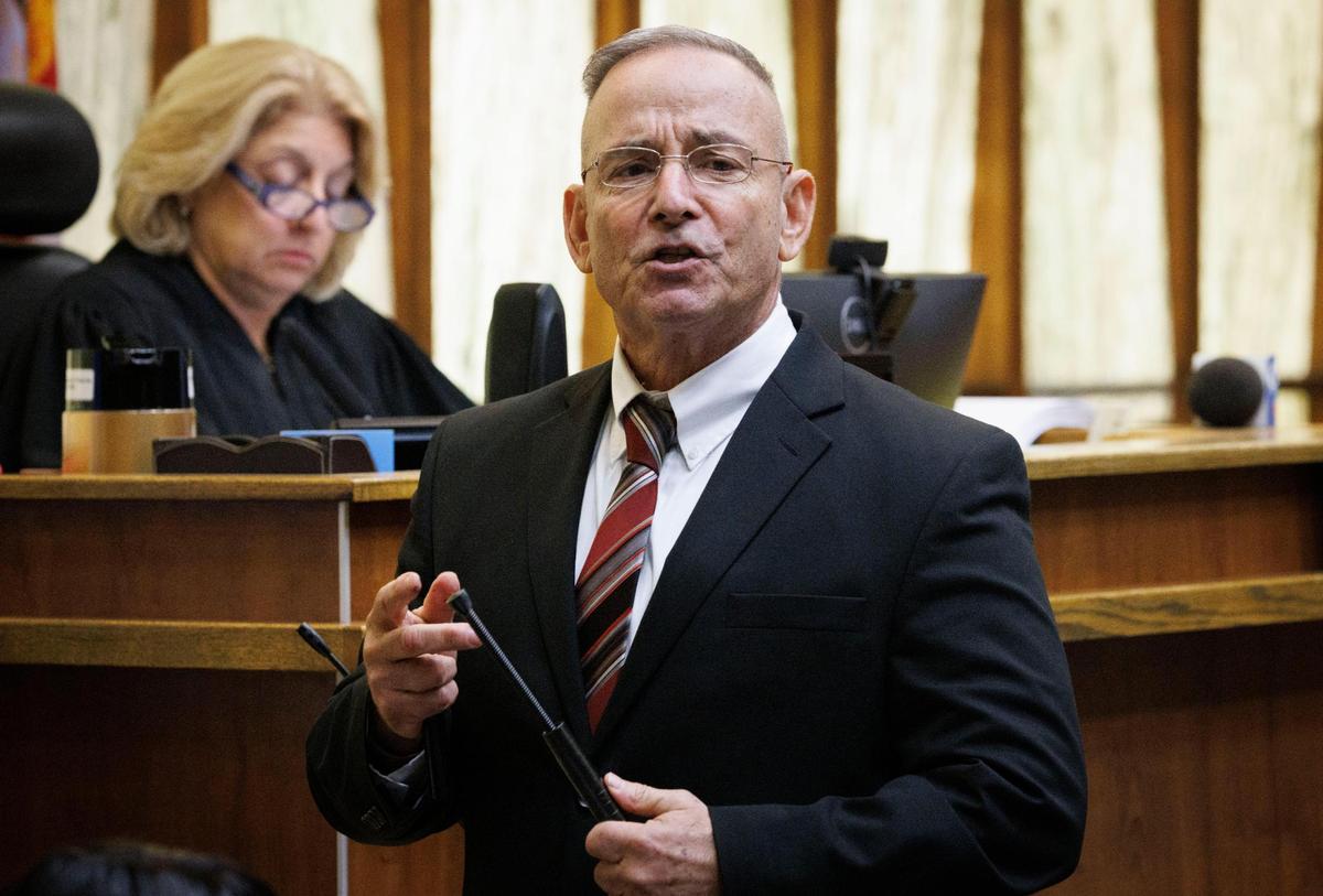 Scott Warfman, an assistant state attorney, shows a weapon that was used in the killings during his opening statement in the death penalty resentencing case of Noel Doorbal and Daniel Lugo on Monday, Dec. 2, 2024, at the Richard E. Gerstein Criminal Courthouse in Miami.