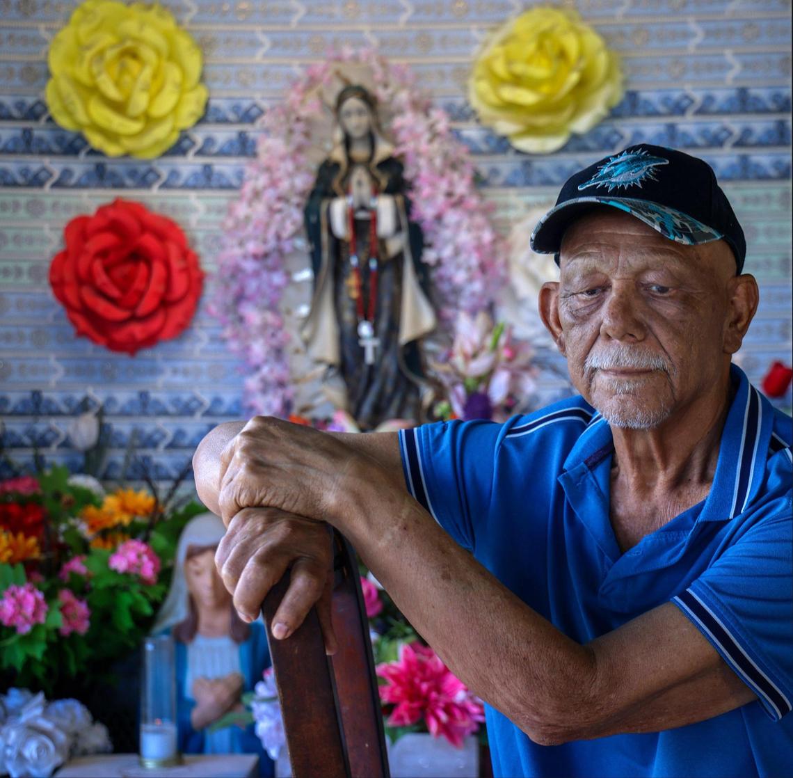Santos Varela, 71, sits in his carport, beneath a shrine to the Virgin of Guadalupe, Mexico’s patron saint, at his mobile home in Li’l Abner Mobile Home Park in Sweetwater, Florida, on Monday, May 19, 2025.