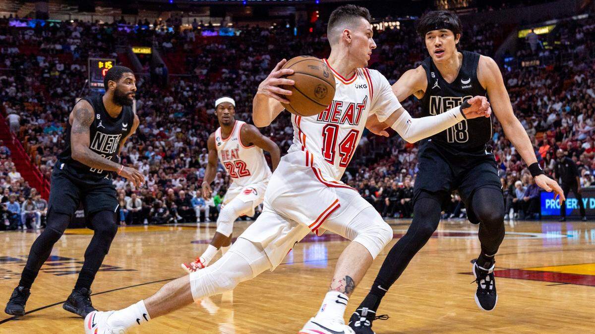 Miami Heat guard Tyler Herro (14) drives on Brooklyn Nets forward Yuta Watanabe (18) during the first half of an NBA game at FTX Arena in Downtown Miami, Florida, on Sunday, January 8, 2023.