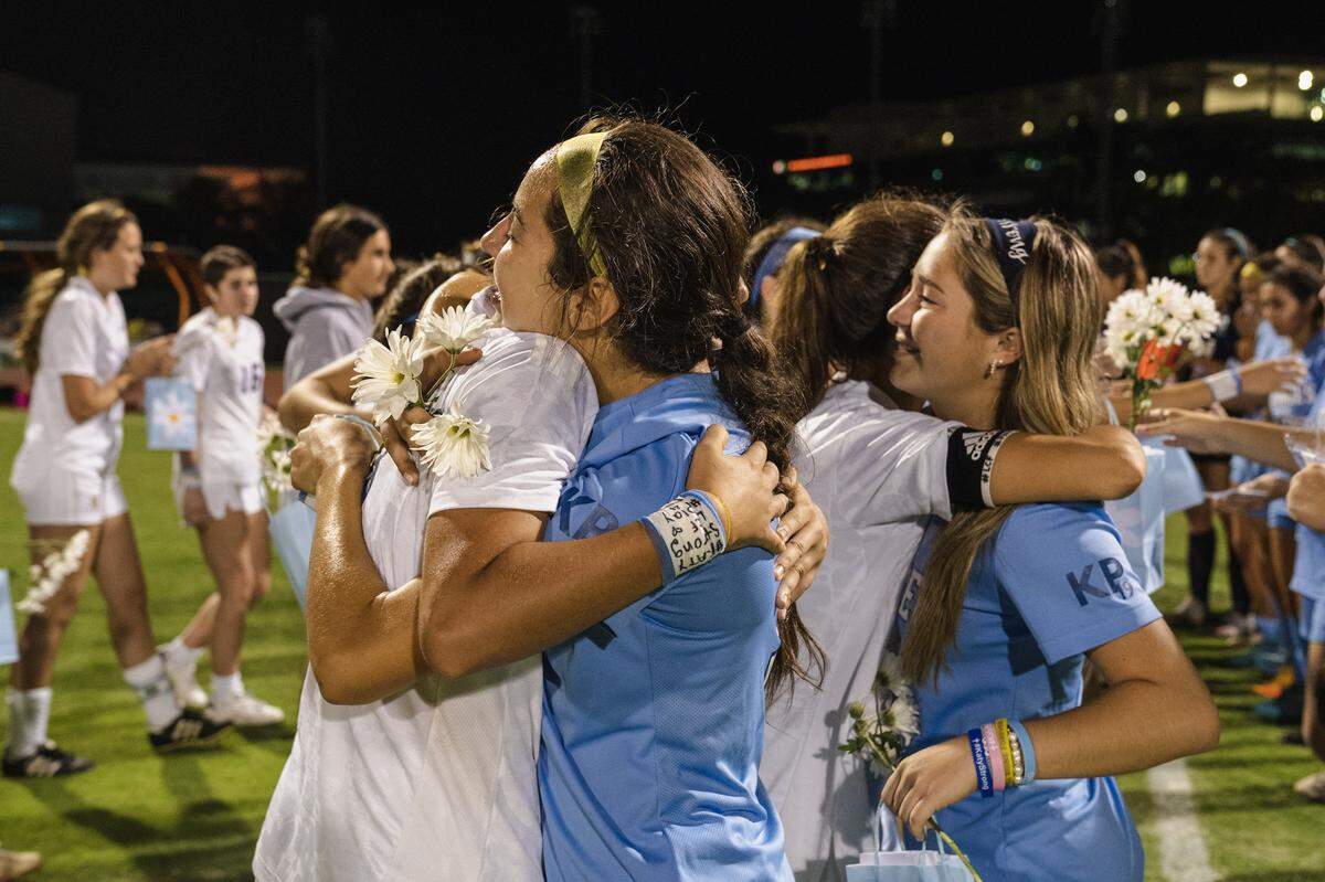Lourdes and Carrollton soccer players including Coco Aguilar, right, embrace after a recent match the two schools dedicated to the memory of Lourdes student Lucy Fernandez, who was killed in the boat crash, and to the recovery of Lourdes soccer star Katy Puig, who has been hospitalized since the crash.