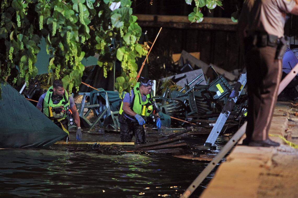 Rescue divers search for missing person after dock collapse at Shuckers on 79th Street Causeway. Thursday June 13, 2013.