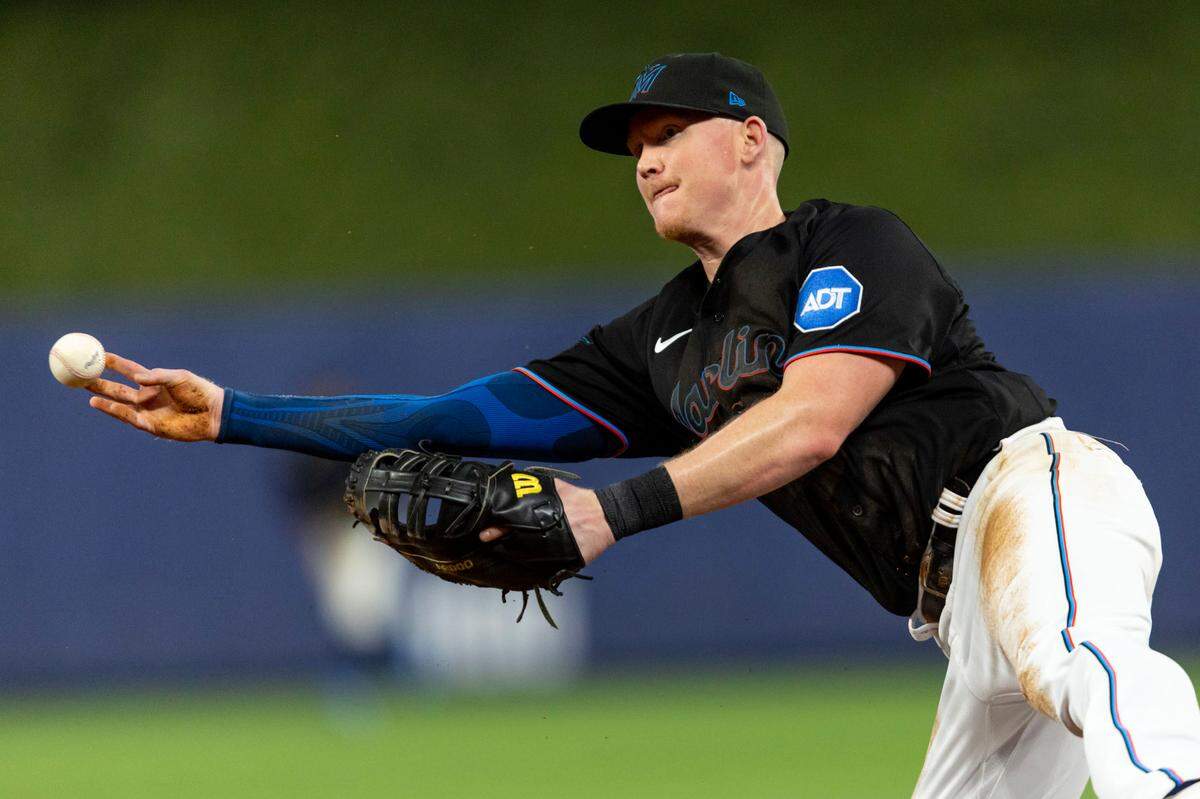 Miami Marlins first baseman Garrett Cooper (26) throws the ball to pitcher Matt Barnes for an out during the sixth inning of an MLB game against the Washington Nationals at loanDepot park in the Little Havana neighborhood of Miami, Florida, on Thursday, May 18, 2023.