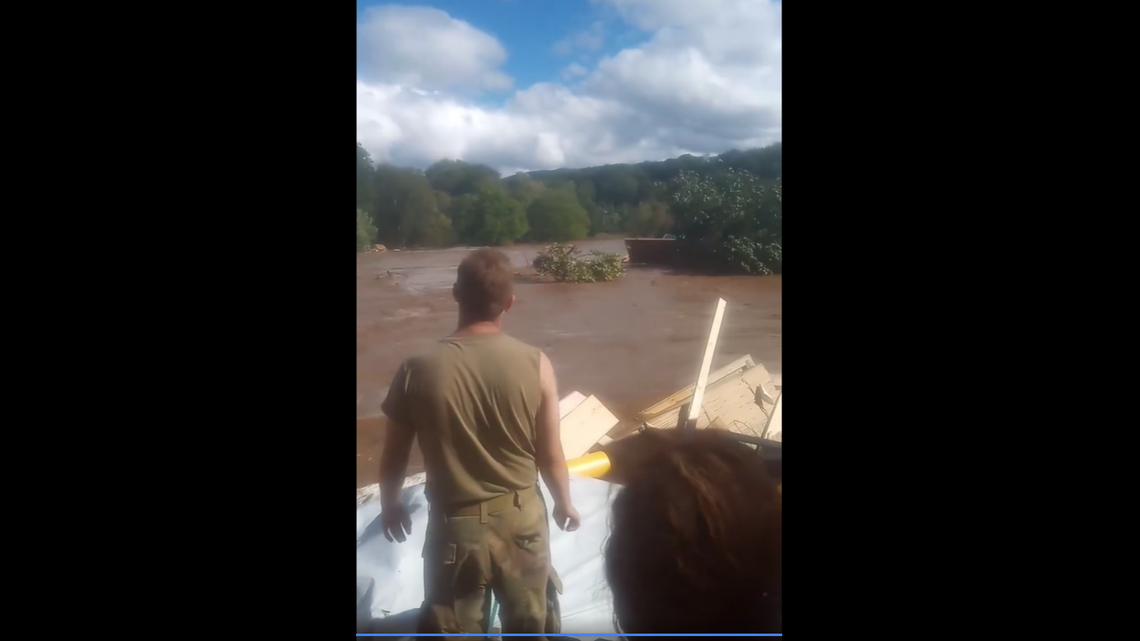 A group of five Impact Plastics employees were swept away by the flood waters on Sept. 27. This video screengrab shows they waited atop a pile of the debris for rescue in Erwin, Tennessee.