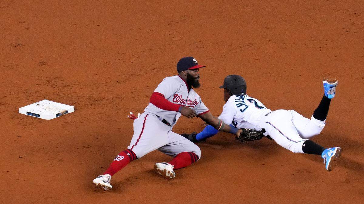 MIAMI, FLORIDA - JUNE 24: Josh Harrison #5 of the Washington Nationals tags out Jazz Chisholm Jr. #2 of the Miami Marlins attempting to steal second base in the first inning at loanDepot park on June 24, 2021 in Miami, Florida. (Photo by Mark Brown/Getty Images)