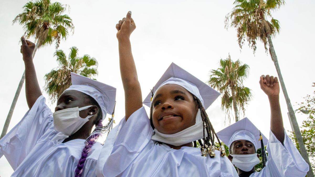 Students throw their fists in the air as a sign of solidarity during the special Juneteenth Commencement Celebration at M.E.Y.G.A. (Multi-Ethnic Youth Group Association) Learning Center in Liberty City on June 19. Bea Hines writes: “Every American child — no matter the color of his or her skin — should be taught the true story of our nation. The story should be taught in a way that no child should feel ashamed. Rather, it should be taught in a way that each child hearing the story would be able to say, ‘Never again!’”