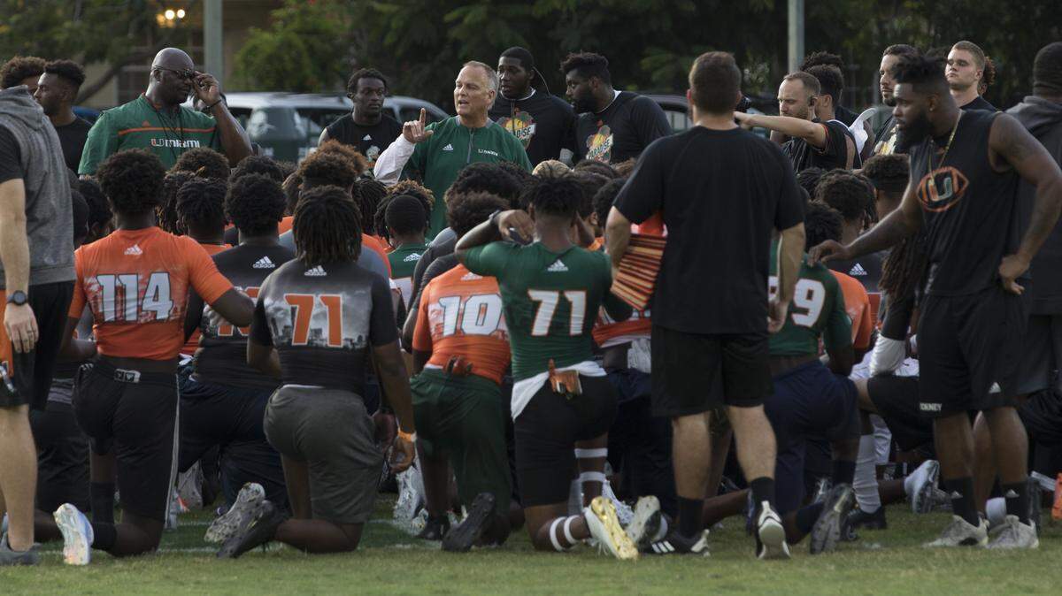 University of Miami Mark Richt huddles with the players during football recruits visited the University of Miami’s campus in Coral Cables for the third annual Paradise Camp on Saturday, July 28, 2018.