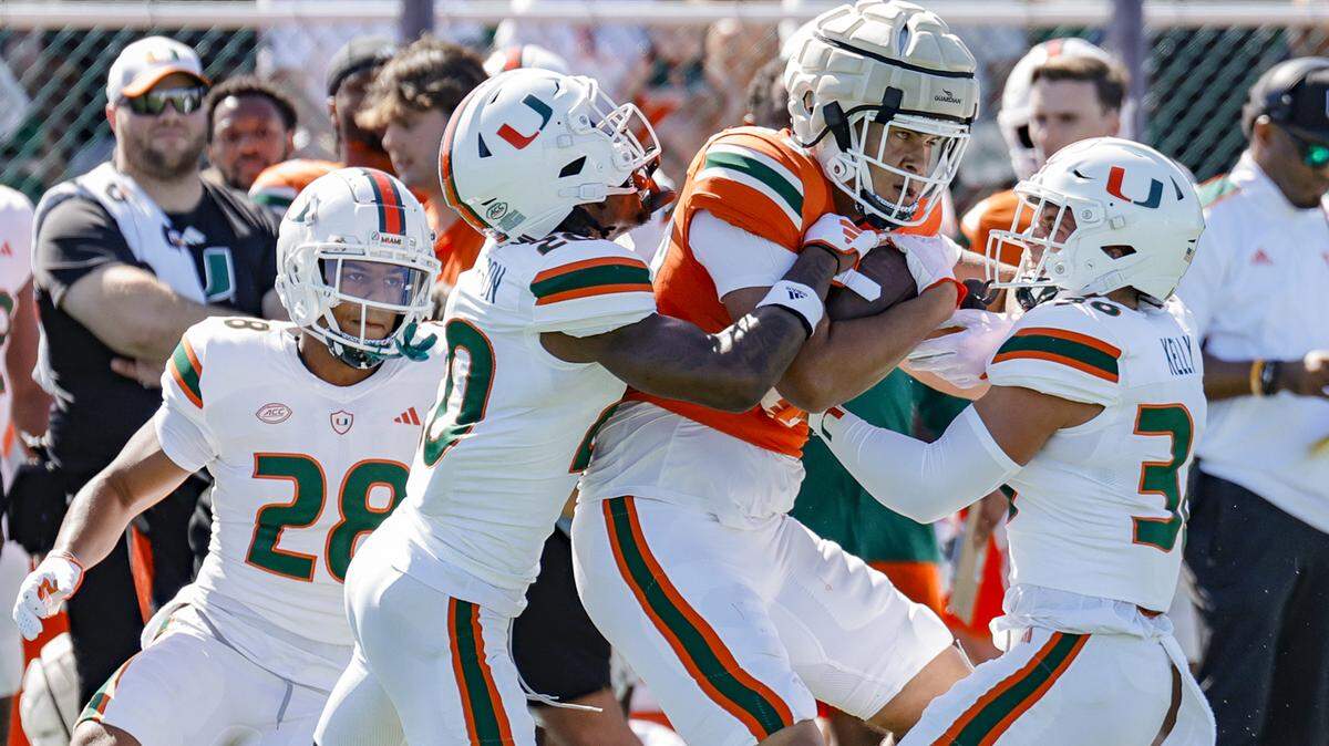 Miami Hurricanes tight end Riley Williams (88) battles Miami Hurricanes safety Nick Kelly (31) and safety Zaquan Patterson (20) for more yardage after a first down reception during the Canes spring football game at the University of Miami’s Cobb Stadium in Coral Gables, Florida on Saturday, April 13, 2024.