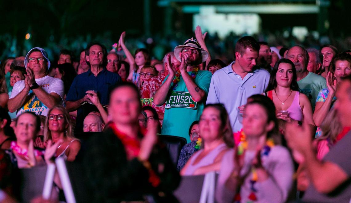 Fans cheer as Jimmy Buffett and his Coral Reefer Band perform during a concert at the iTHINK Financial Amphitheatre in West Palm Beach, Florida on Thursday, December 9, 2021.
