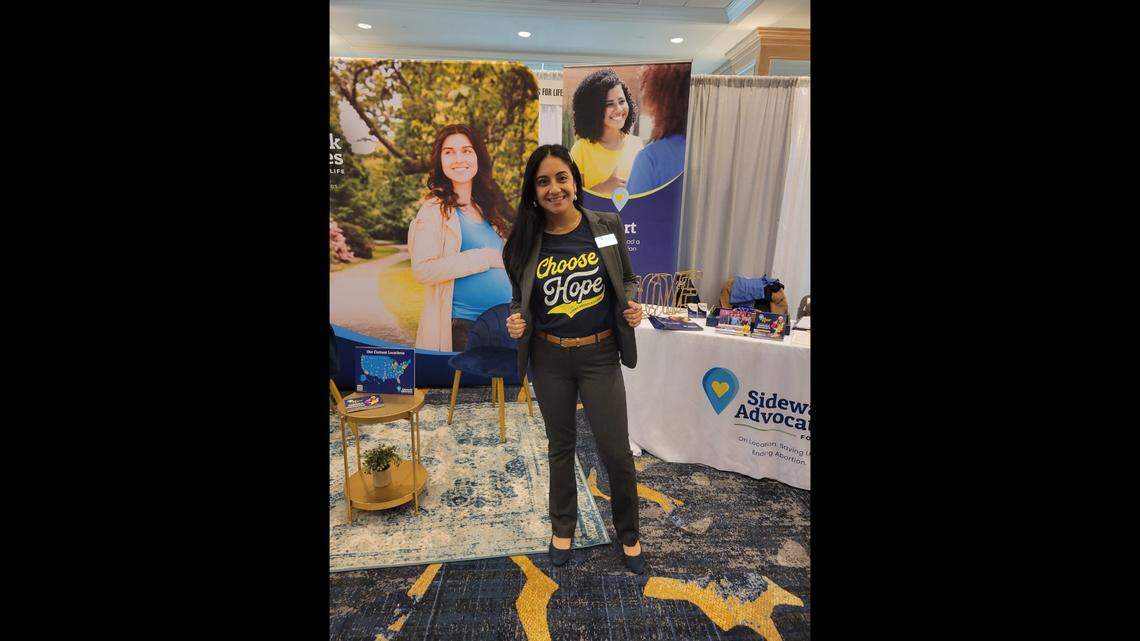 Linda Fernandez wearing a “Choose Hope” shirt in front of a Sidewalk Advocates for Life booth.