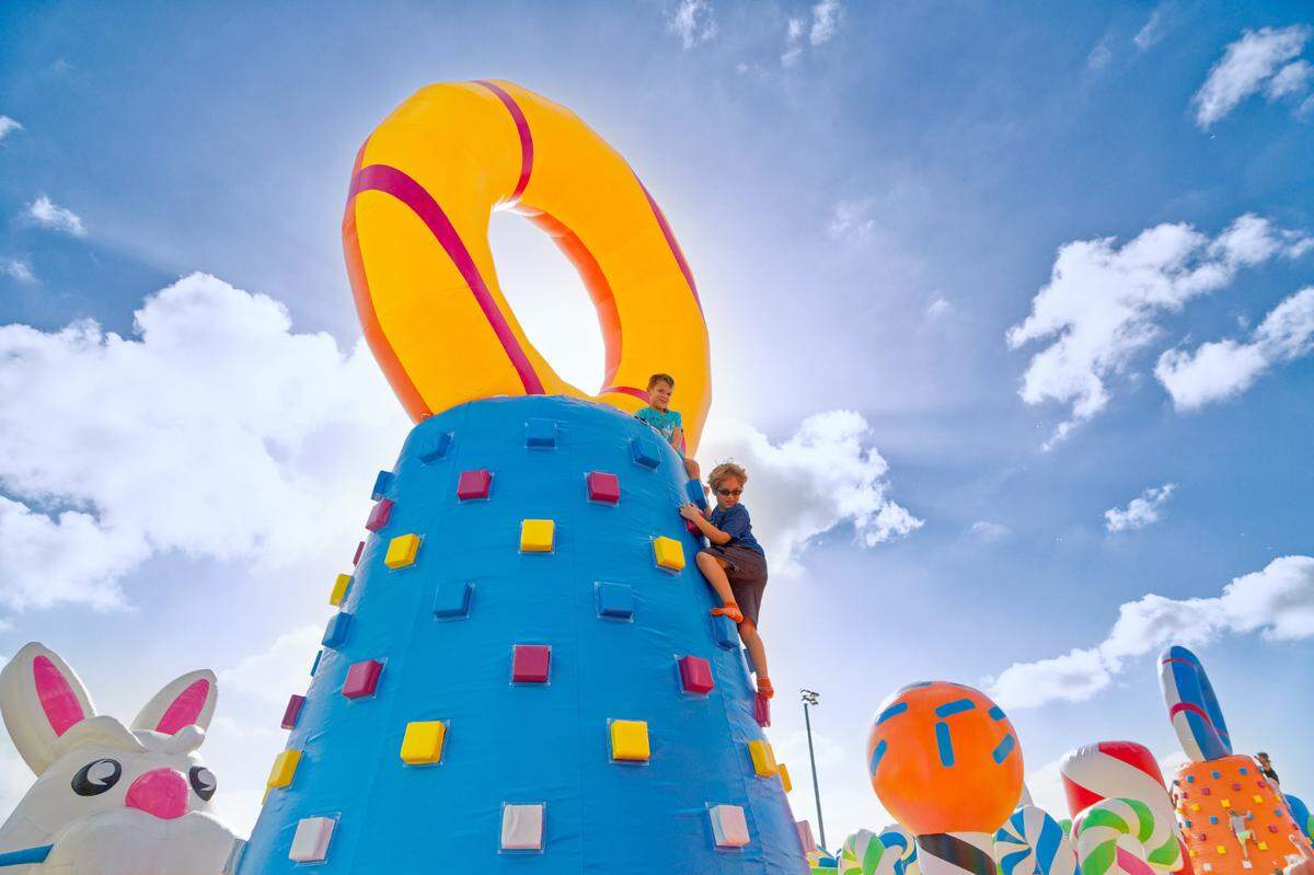 Kids on an inflatable climbing tower at The Big Bounce America, which is coming to Miami.