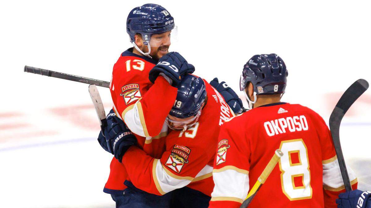 Florida Panthers left wing Matthew Tkachuk (19) hugs  center Sam Reinhart (13) after Reinhart scored the winning goal against the New York Rangers during overtime of Game 4 of the Eastern Conference finals of the NHL hockey Stanley Cup playoffs at the Amerant Bank Arena on Tuesday, May 28, 2024, in Sunrise, Fla. 