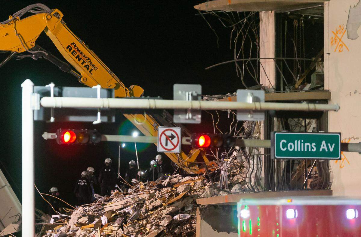 South Florida Urban Search and Rescue team look through rubble for survivors at the partially collapsed Champlain Towers South Condo building in Surfside, Florida on Wednesday, June 30, 2021.