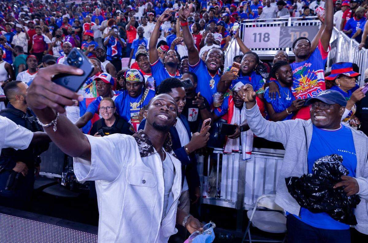 Woodensky Pierre, midfielder of the Haitian national team, poses for photos with fans after arriving in Fort Lauderdale on Tuesday, June 2, 2026, in time to see the team rout New Zealand, 4-0, in a pre-World Cup friendly game. Pierre’s U.S. arrival had been delayed because of issues in securing a visa.
