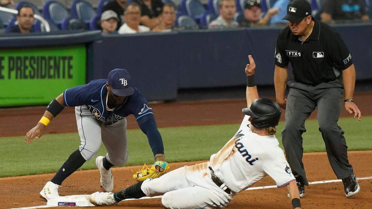 Tampa Bay Rays third baseman Yandy Diaz tags Miami Marlins’ Luke Williams during the third inning of a baseball game, Tuesday, Aug. 30, 2022, in Miami. (AP Photo/Marta Lavandier)