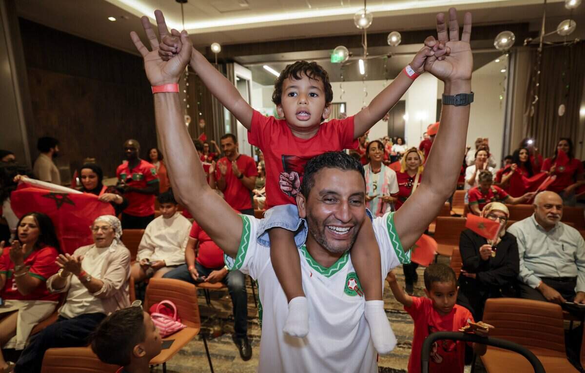 Abdellatif Zrouri reacts as he carries his son Ali Zrouri, 3, at the Morocco World Cup Watch Party at the Thesis Hotel in Coral Gables, Florida, during the soccer match between Morocco and Brazil on Saturday, June 13, 2026.